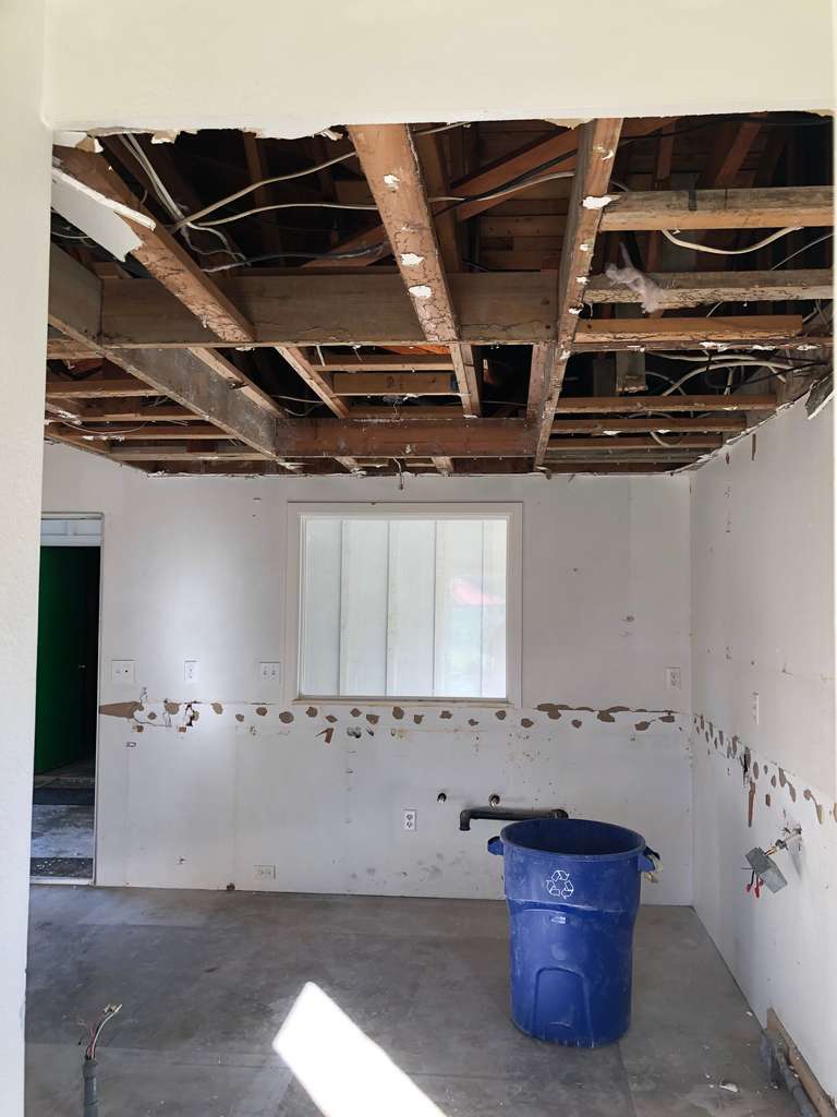 old drywall removed exposing the ceiling joists