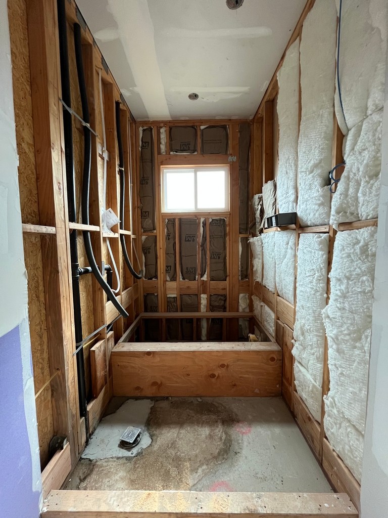 ADU bathroom framing plumbing and insulation rough-in.