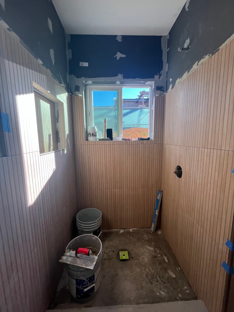 bathroom with plumbing rough-ins and finish prep underway.