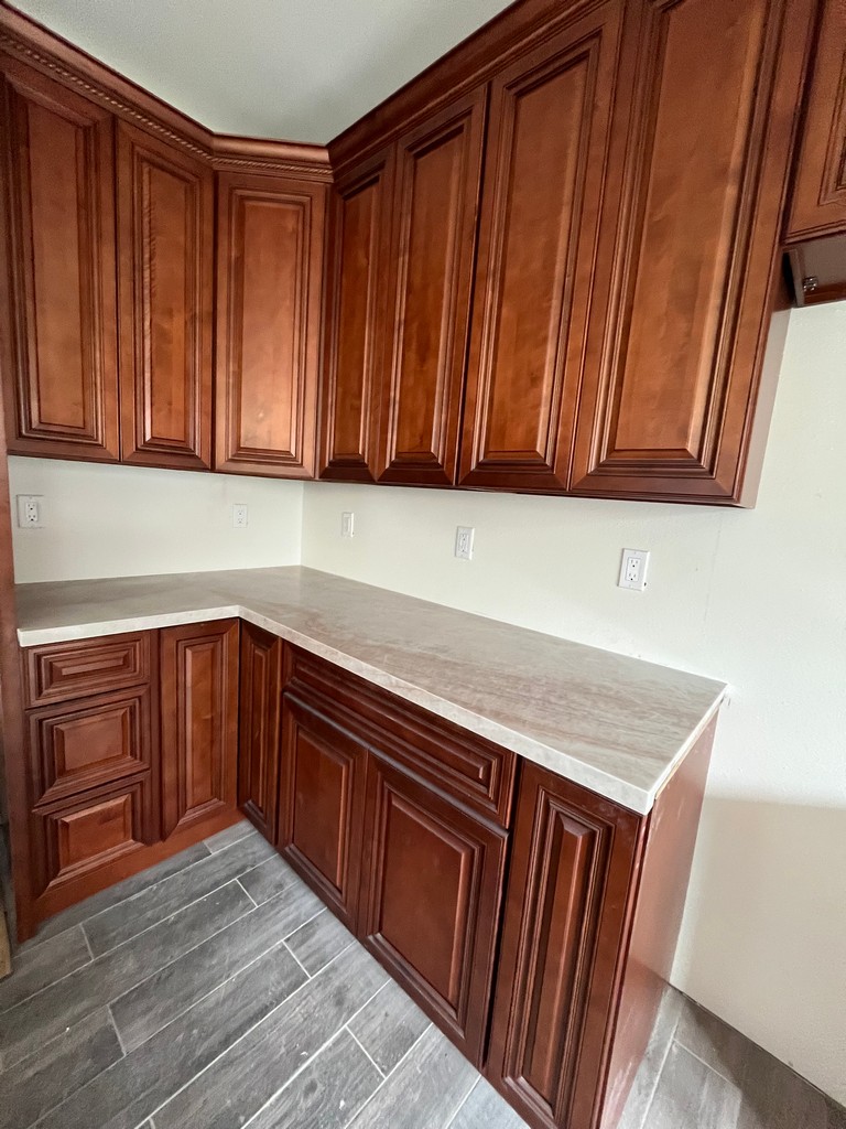 Corner kitchen cabinets with countertop installed.