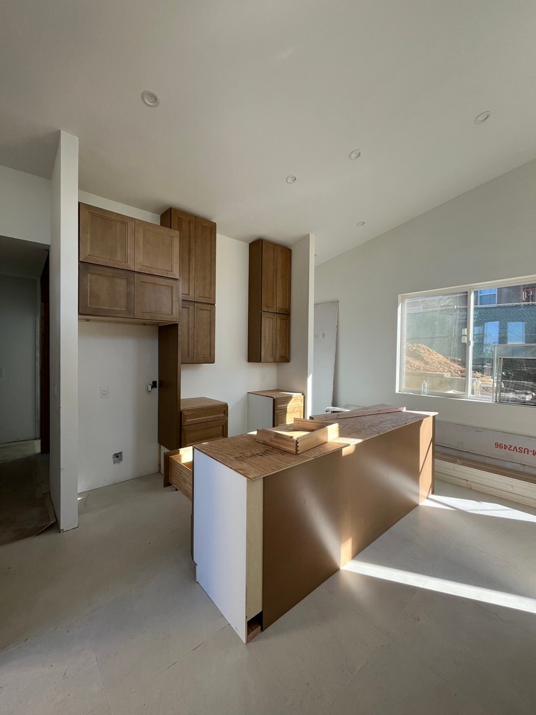 Wall cabinets and pantry units installed in residential kitchen.