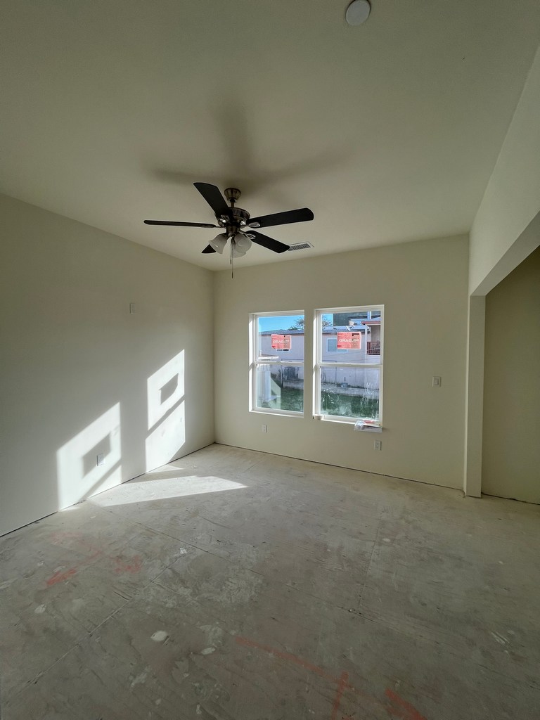 Interior living space shows completed walls with installed windows.