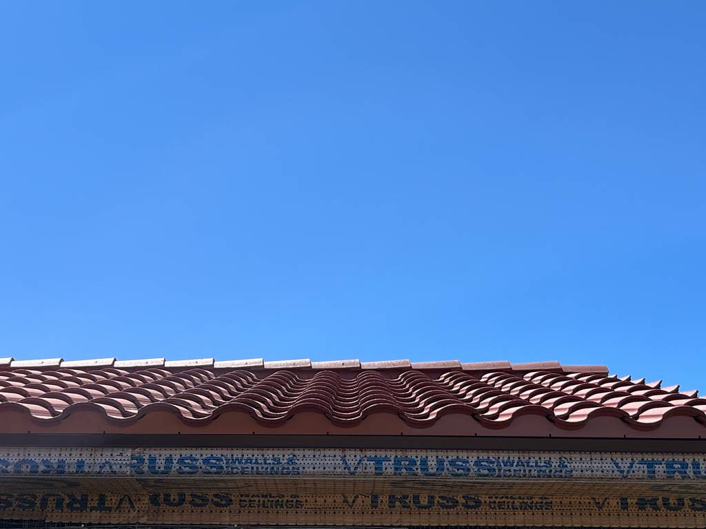 Precise and expert installation of clay tiles on prepared roof