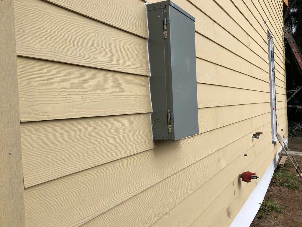 Electrician installing the power panel with a2mContractors