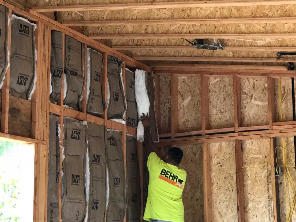 a2mContractors filling the stud cavity with Fiberglass Batt Insulation