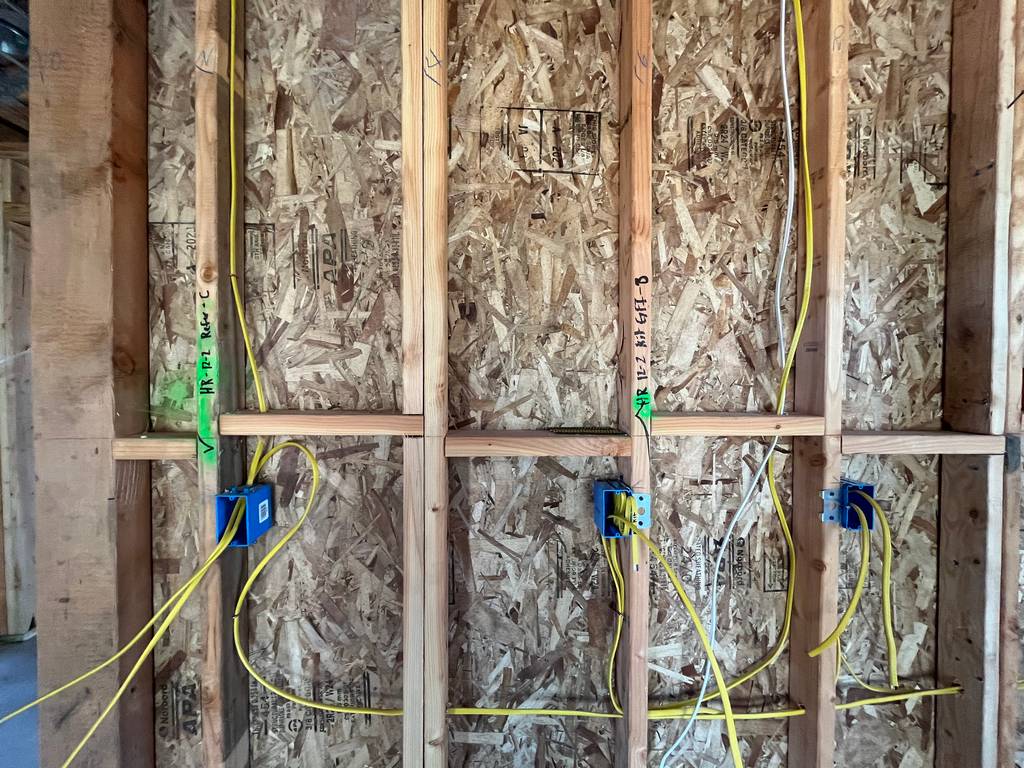 romex wires rounted through open wall studs