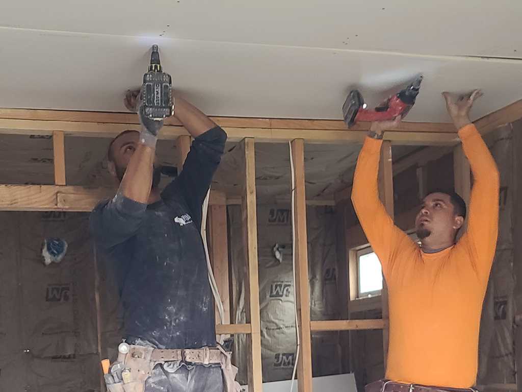 92_ADU showing-drywallwall-being-secured-to-the-ceiling-joists.JPG
