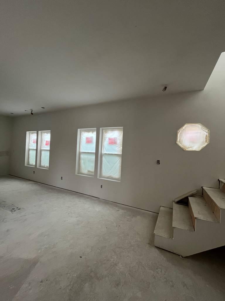 Framed stairs with stringers and treads in progress during remodel.