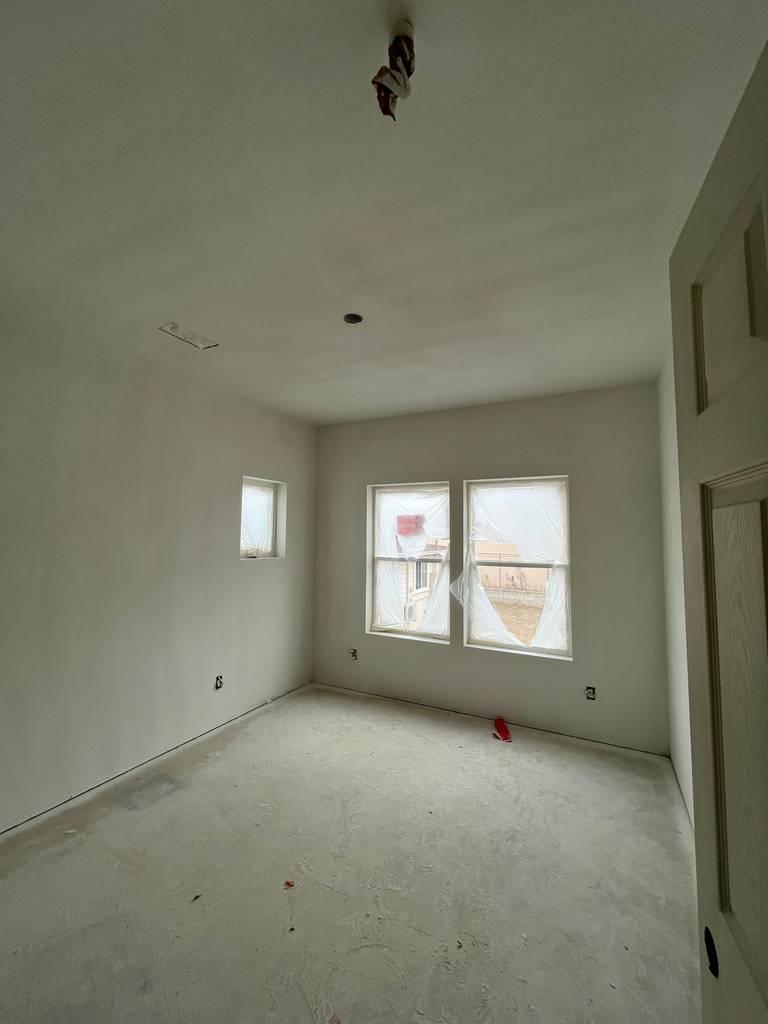 Drywall installation showing panels fitted and seams visible.