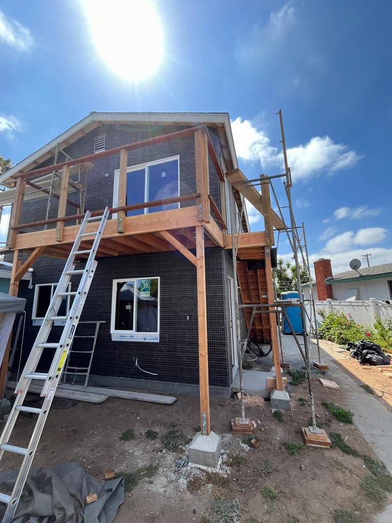 ADU balcony stairway framing with vinyl windows.
