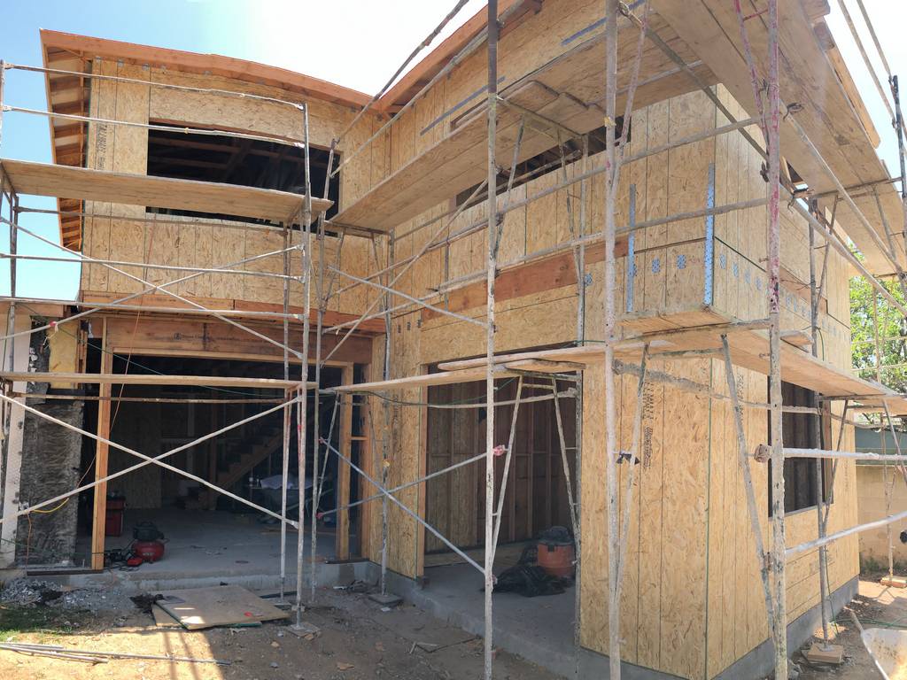 sheathing the exterior walls of the home addition
