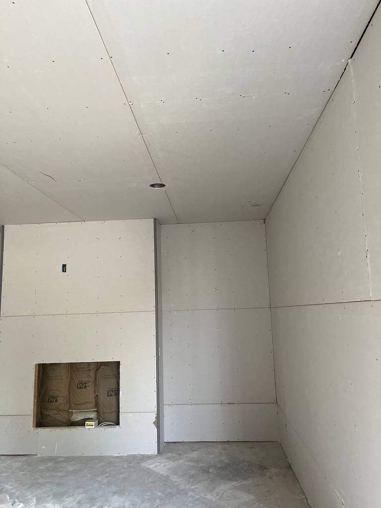 drywall on the walls and ceiling of the living room for the home addition