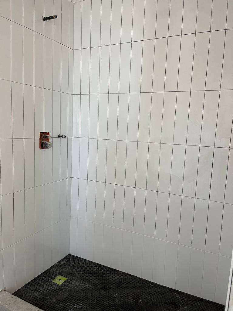 working on the shower vertical subway tiles