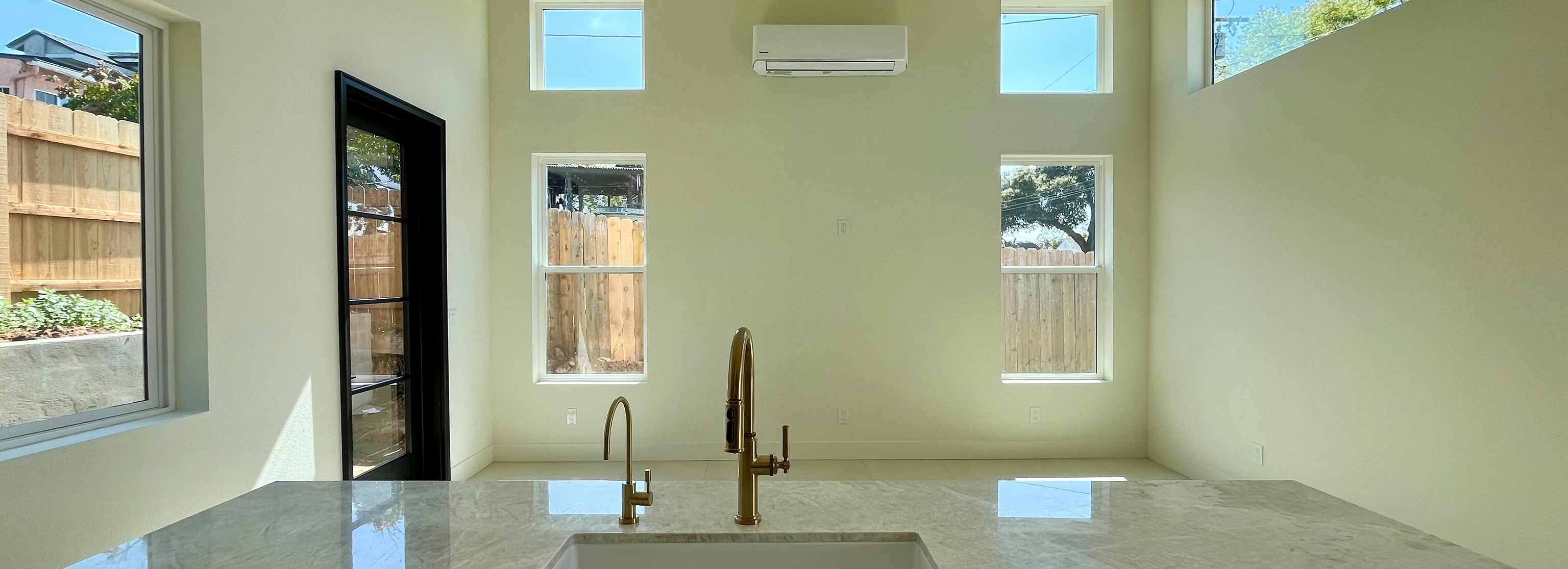 ADU interior shows completed kitchen cabinet installation, appliance placement, and countertop surfaces.