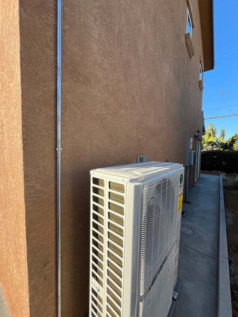 Exterior stucco wall with HVAC condenser clearance on residential new build