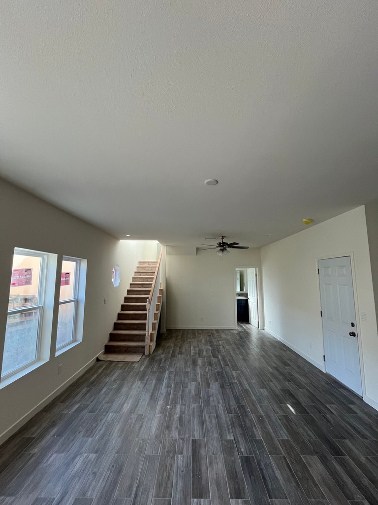 Finished main living area with stairway and installed flooring.