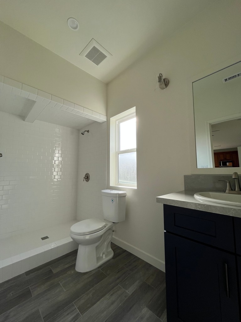 Freestanding tub beside glass shower.
