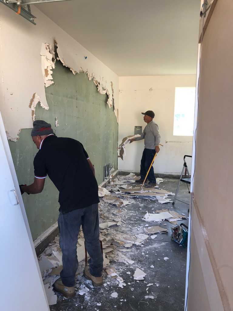garage conversion old inner drywall being removed