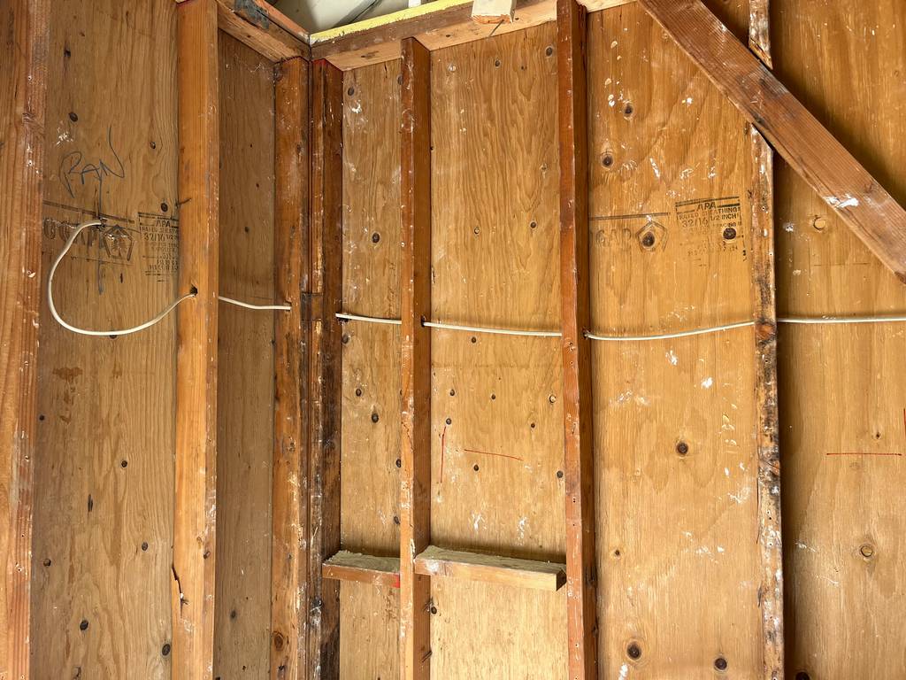 2d_renovation in-action-exposed-garage-framework-electrical-connections