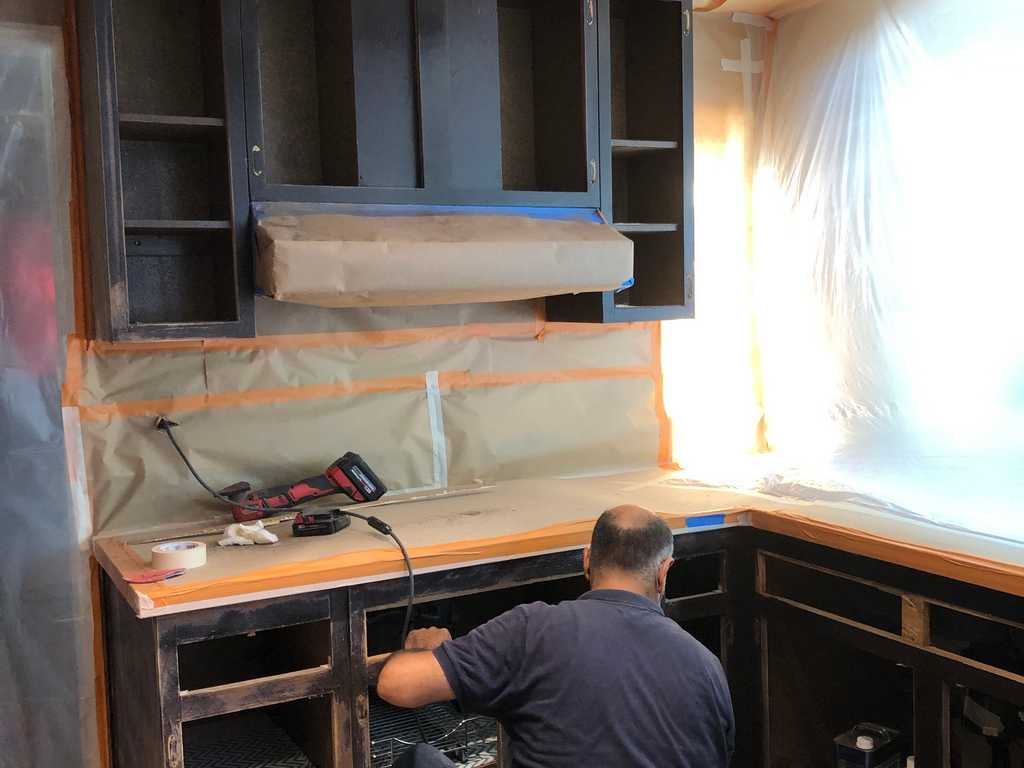 applying visqueen and paper to protect exposed areas, a2mContractors