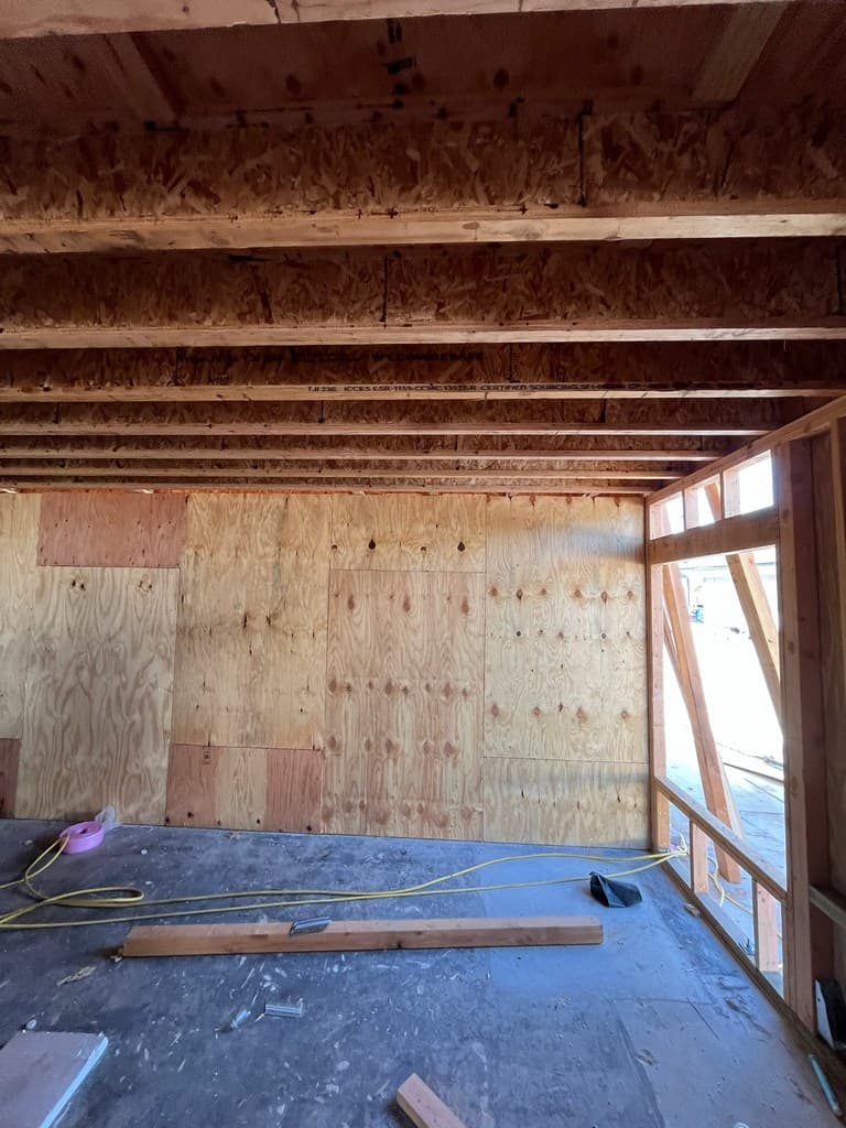 Plywood sheathing inside framed guest quarters room.