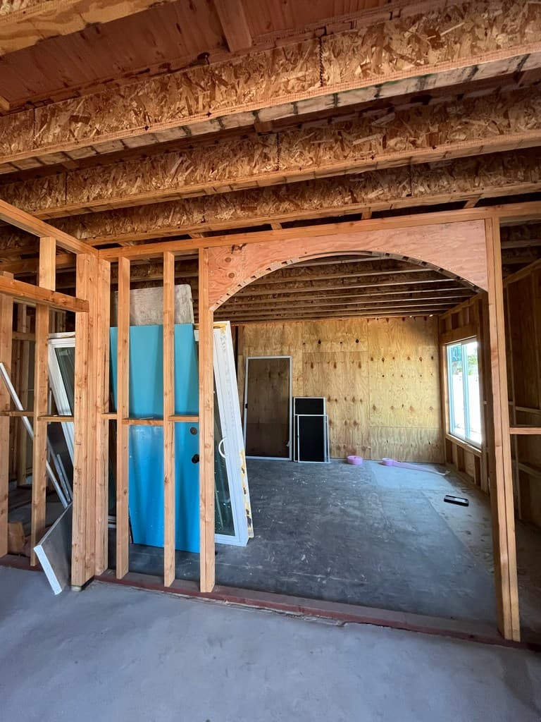 Arched opening framing between remodeled living spaces.