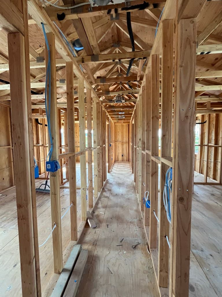 Framed ADU hallway with electrical rough-in.
