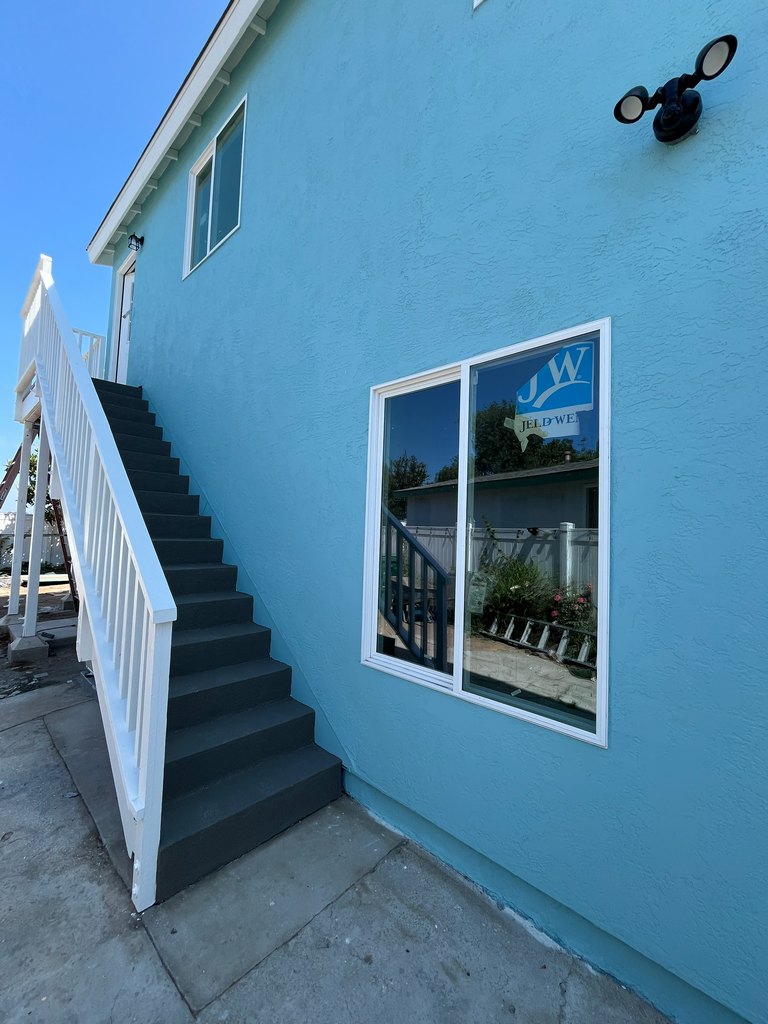 Blue stucco with finished exterior stairs