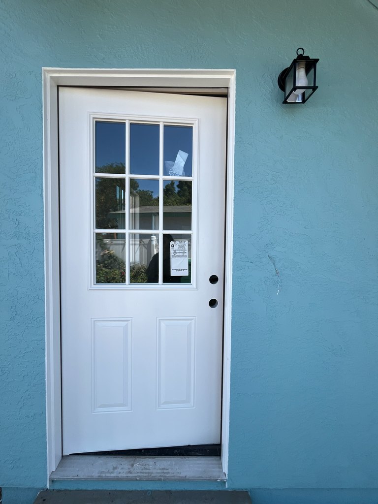 White entry door with exterior lantern