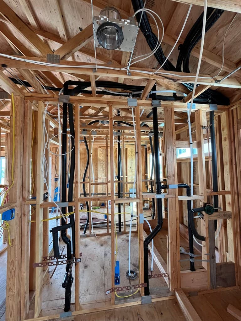 ADU wall framing with plumbing and wiring.