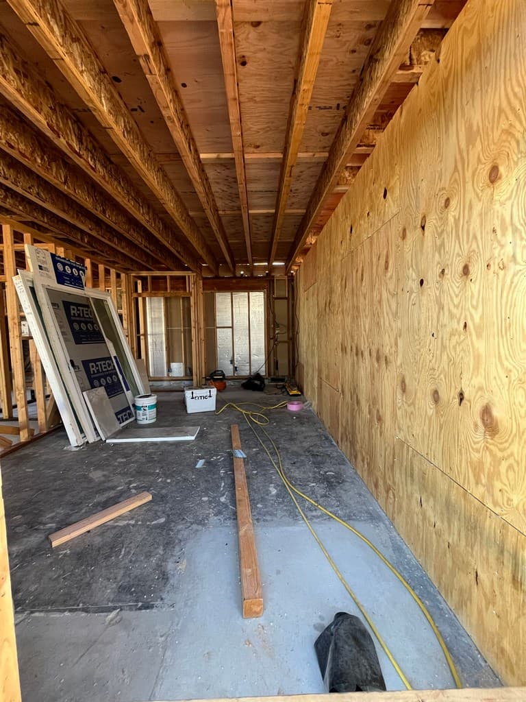 Staged vinyl windows inside guest quarters shell.