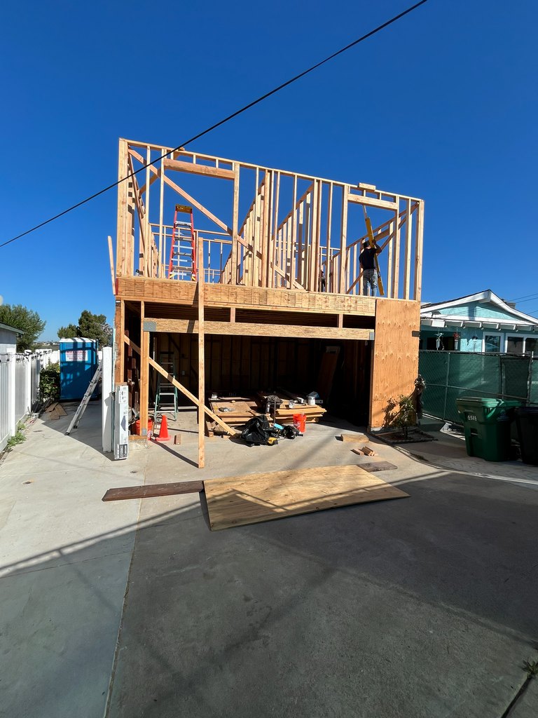 Worker installing upper guest quarters wall framing