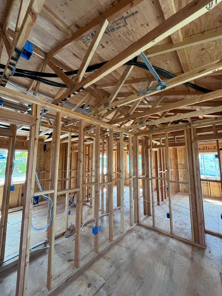 exposed roof trusses with electrical wiring, outlet boxes