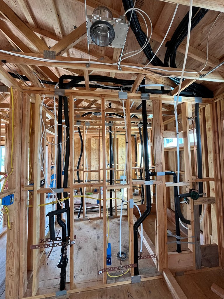 Framed utility wall containing multiple drain, vent