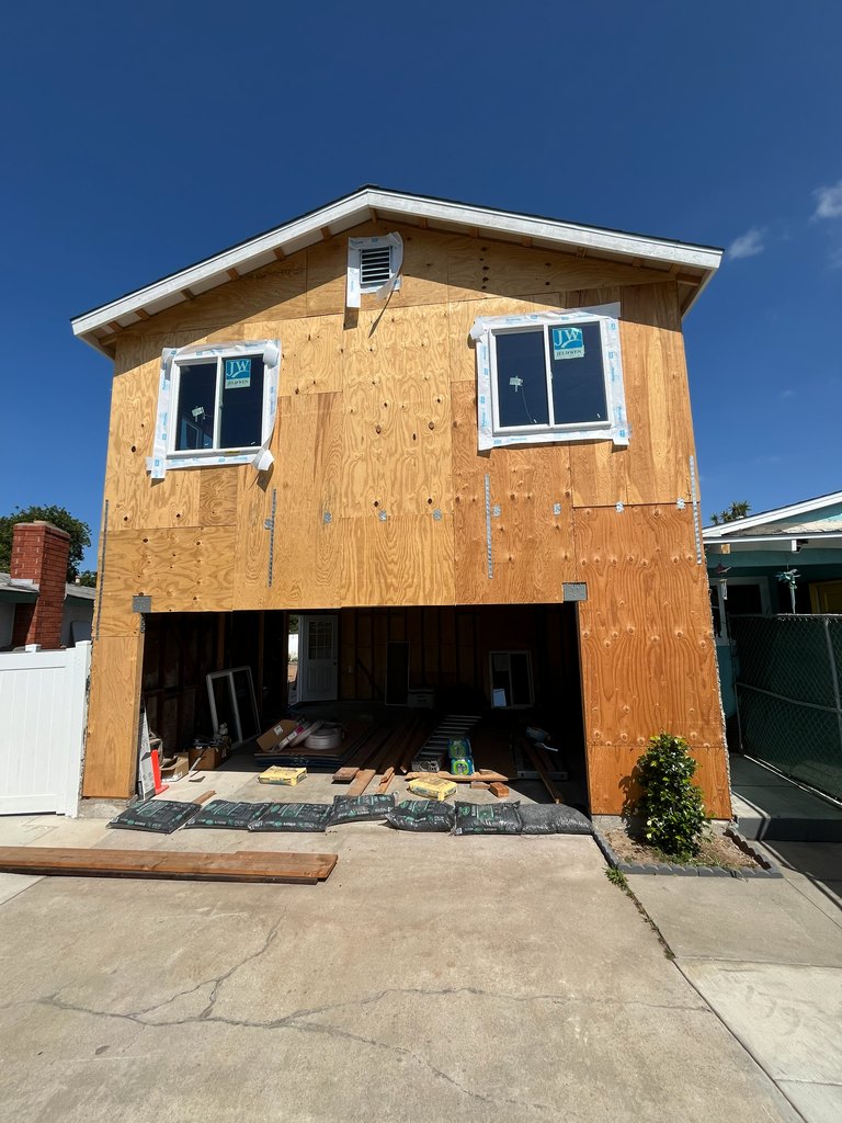 upper-story windows, a roof vent, structural plywood sheathing
