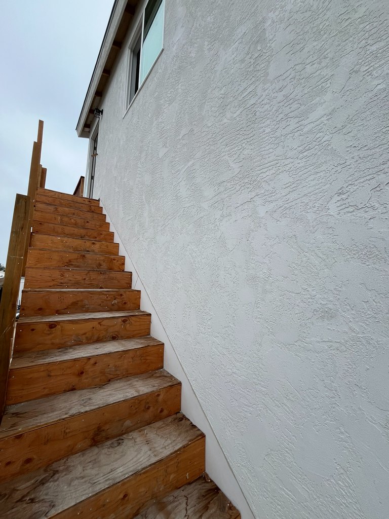 Exterior staircase leading to the upper-level entrance