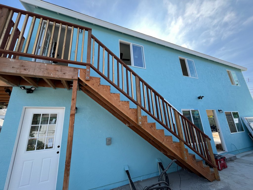 exterior staircase, wood railings, upper landing