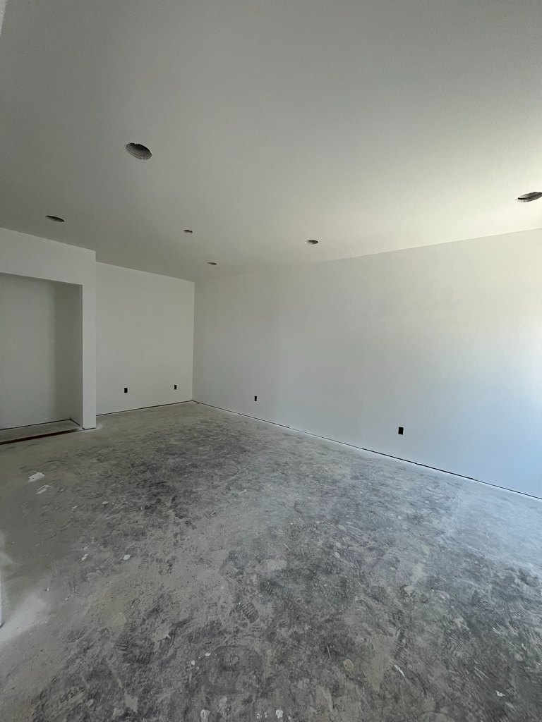 ompleted drywall and white paint, multiple recessed-light openings