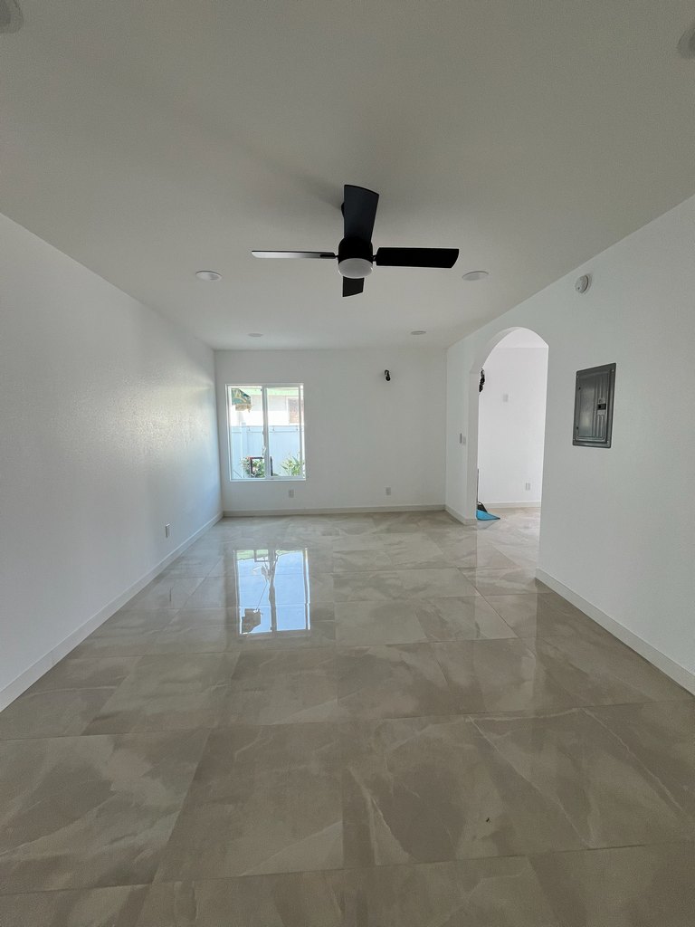 olished tile flooring, white walls, installed recessed lighting