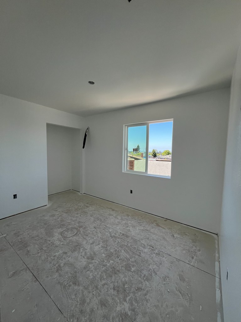 liding window, recessed closet area, unfinished flooring, and ceiling fixture
