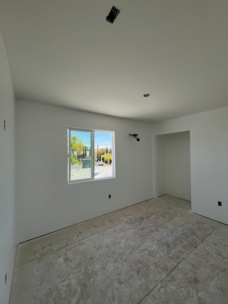  a large sliding window, closet opening, electrical outlet locations, unfinished subfloor