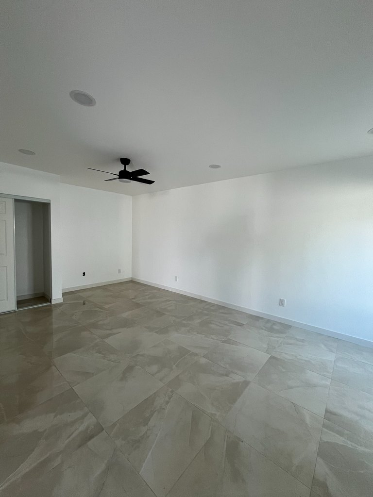 upper-level room with glossy large-format tile flooring, white baseboards, recessed lights