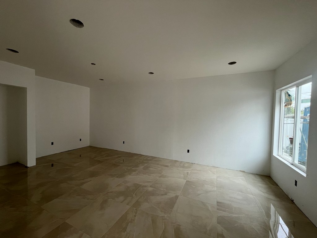 installed large-format tile flooring, painted walls, a sliding window