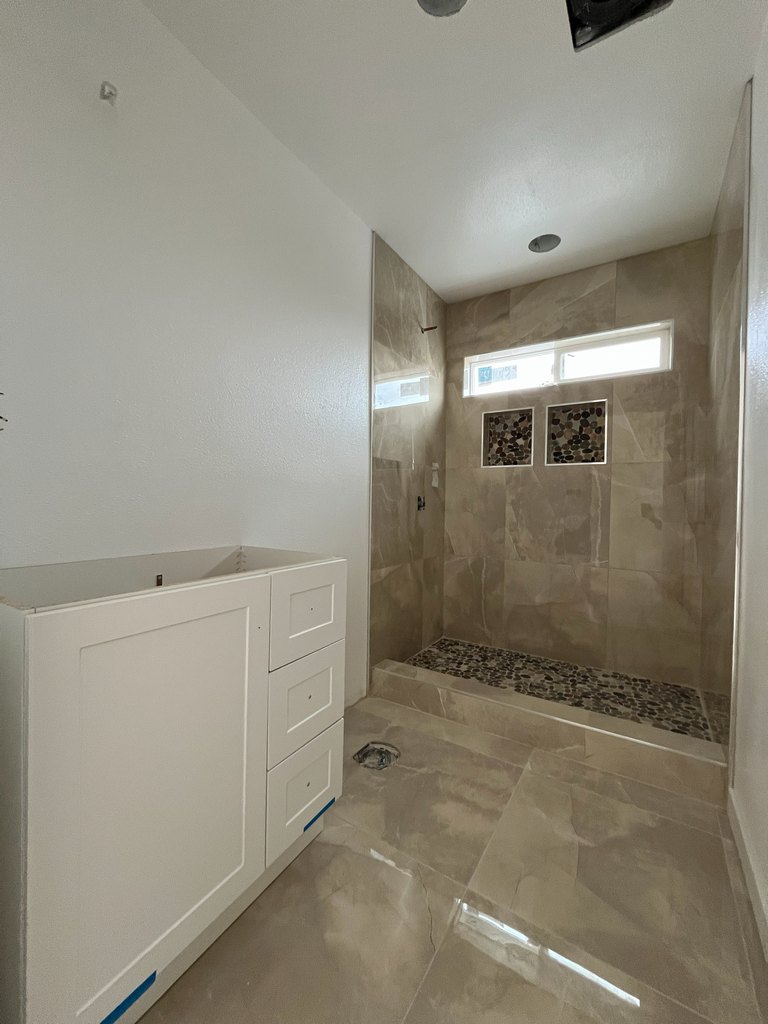 Vanity cabinet facing twin-niche shower