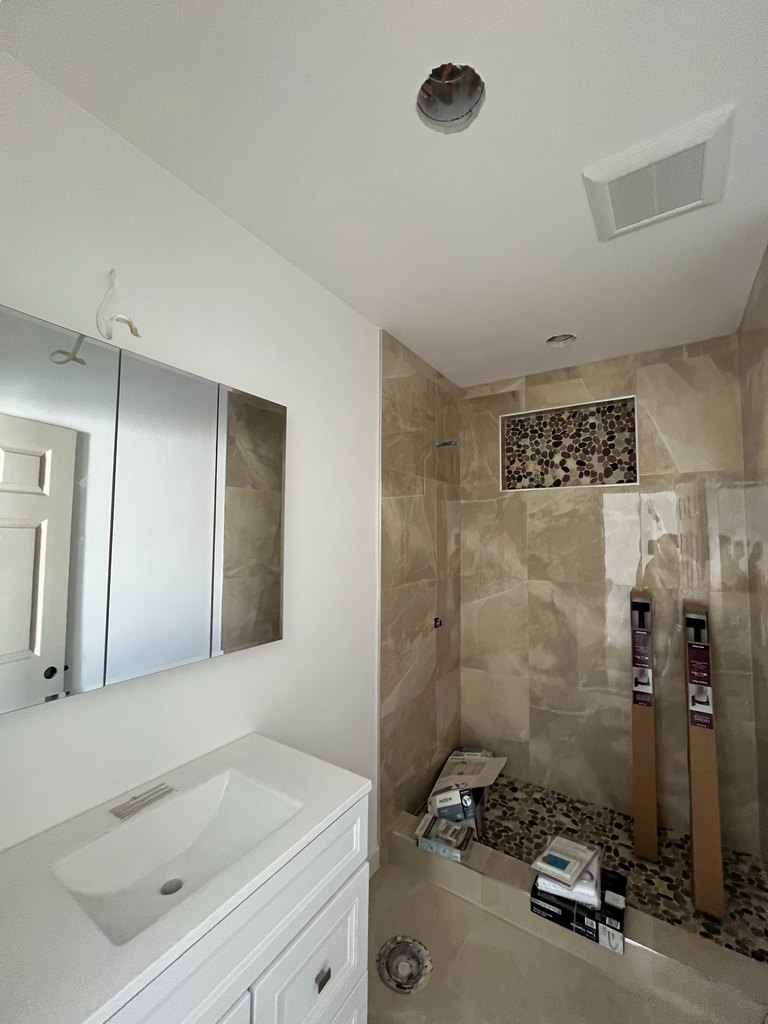 Sink vanity and mirrored cabinet installation