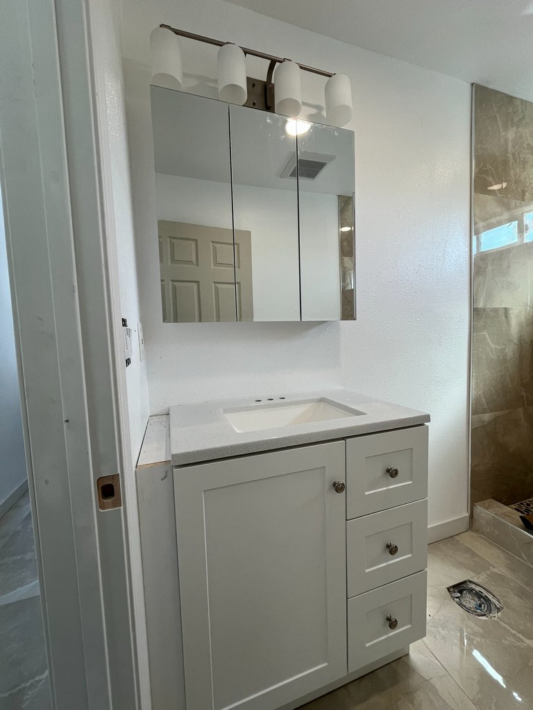 Vanity mirror with four-light fixture