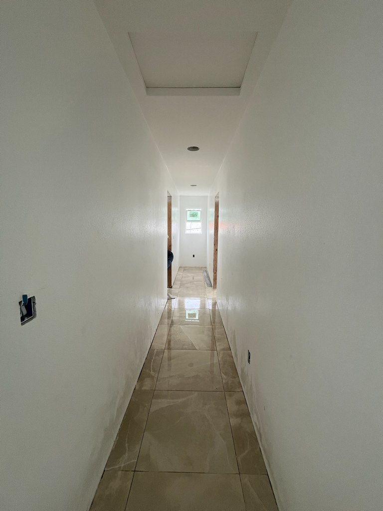 Tiled hallway with ceiling access panel