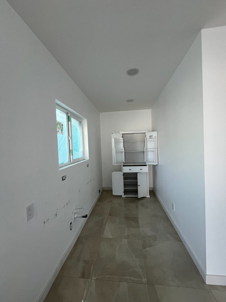 Finished utility room with storage cabinet