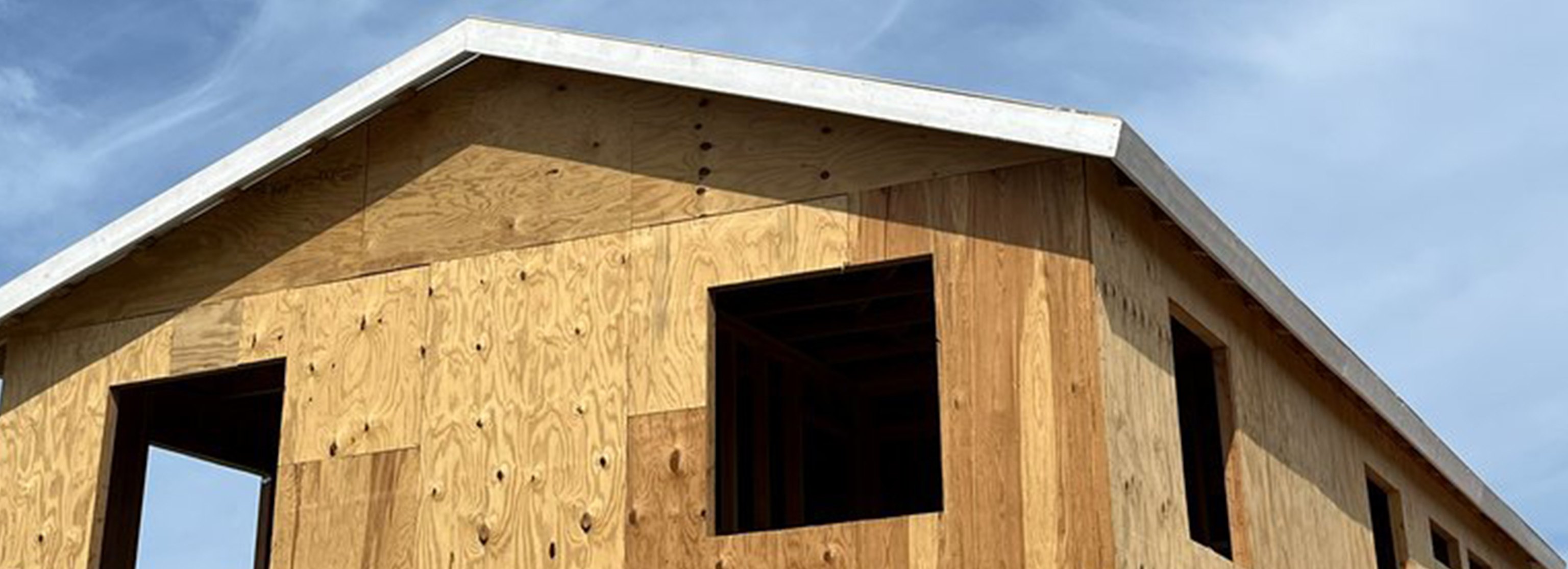 structural plywood sheathing, open upper window openings