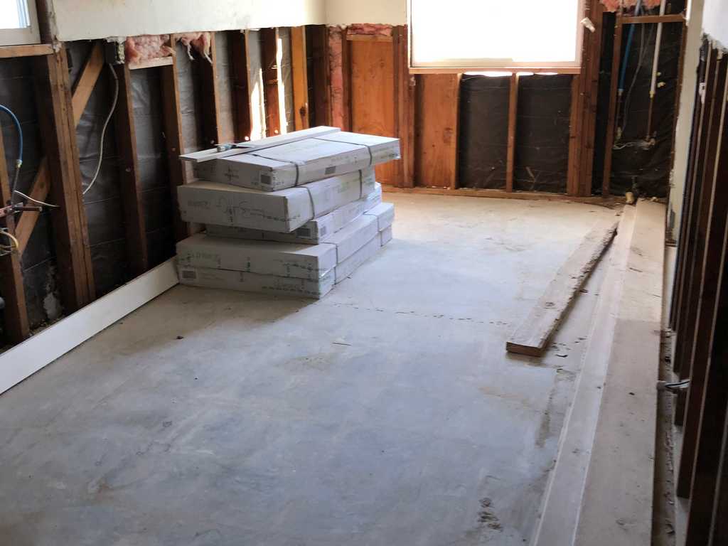 a2mContractors showing work done to expose studs for a front room remodel